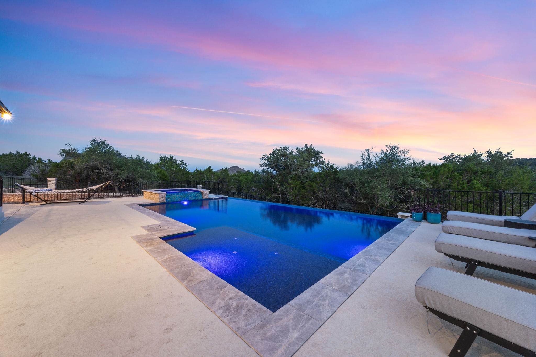 Custom pool at sunset built by Asante Pools in the Texas Hill Country